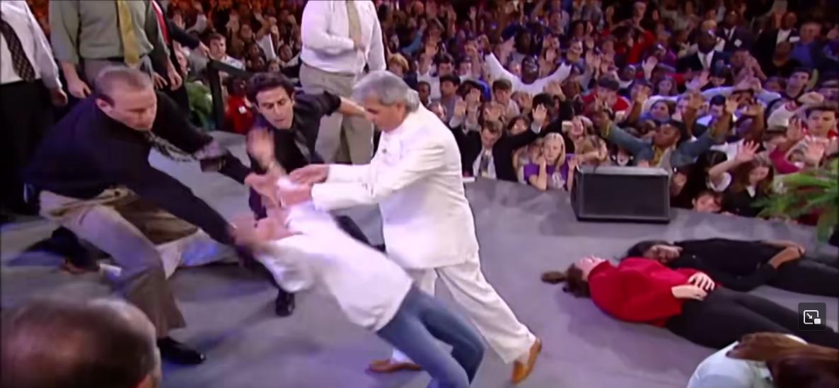 benny-hinn-laying-hands-on-stage-v=4QDAC4JjTjg.jpg
